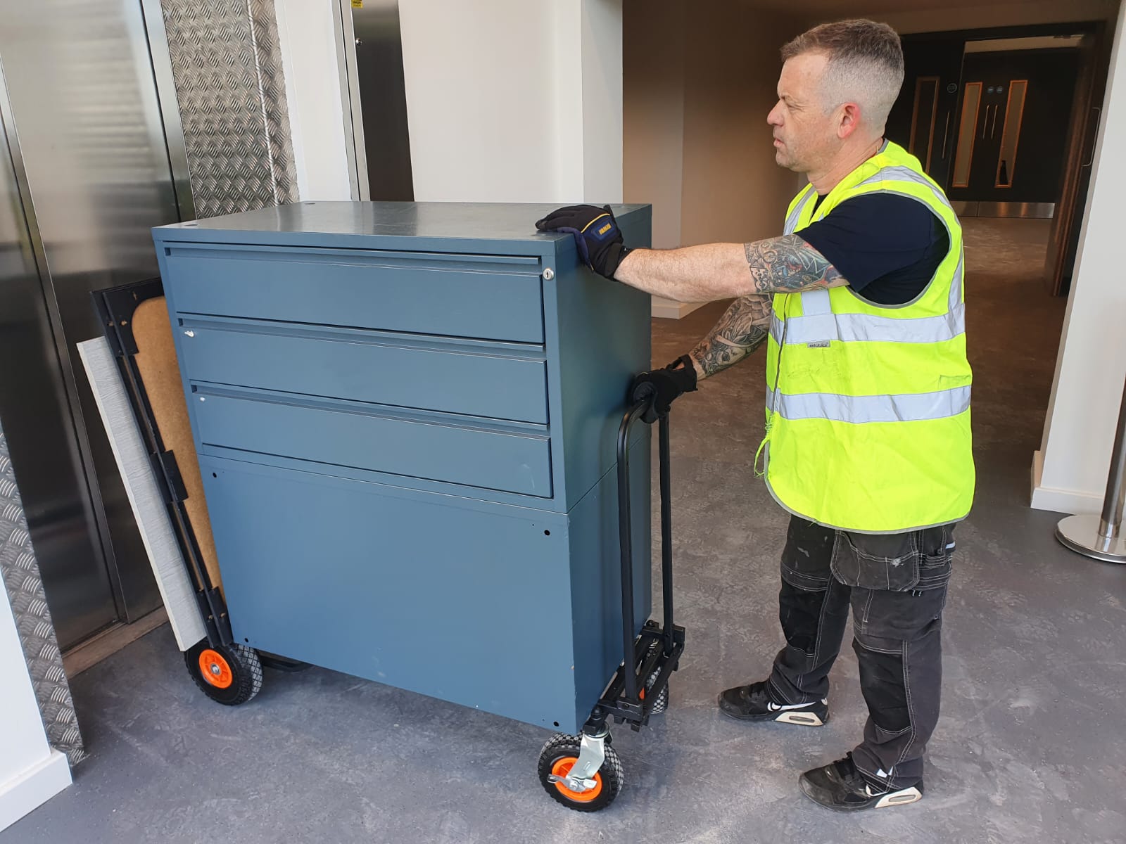 Image of a Clearance Operative Wheeling Office Furniture items on a dolly for clearance
