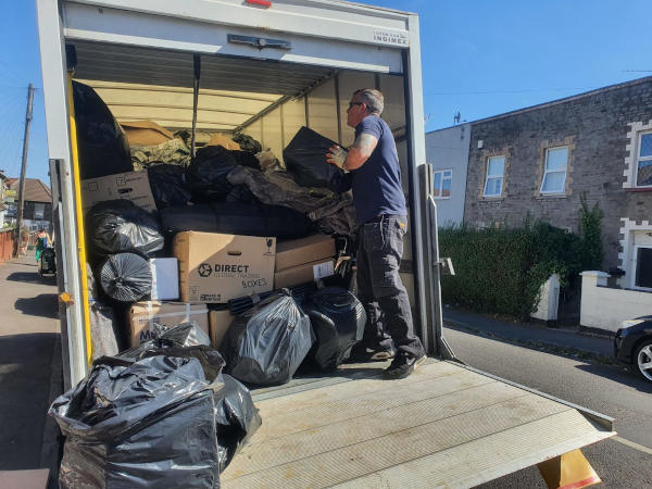 Person loading waste and recyclables on to a van